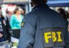 FBI agent in a jacket with 'FBI' on the back at a public event
