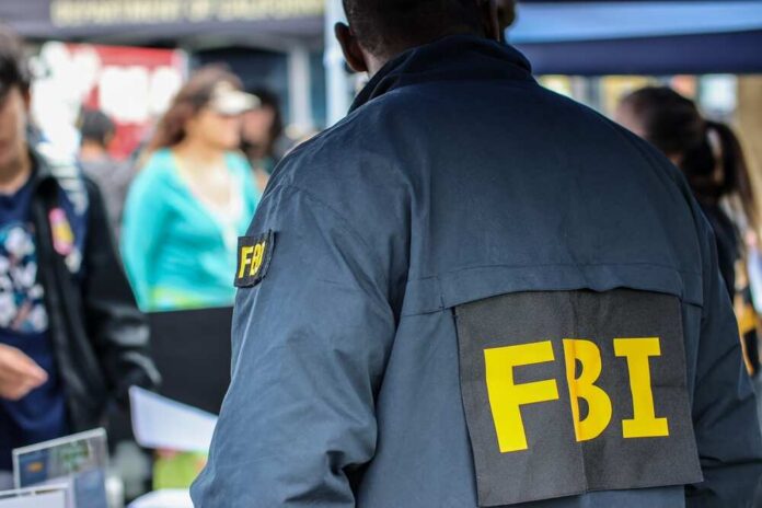 FBI agent in a jacket with 'FBI' on the back at a public event