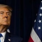 Monument Wars: Trump’s $30M Contest Fury A political figure looking upward beside an American flag