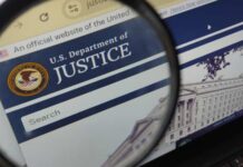 Close-up view of the U.S. Department of Justice website through a magnifying glass