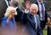 Royal couple waving to the crowd during a public event