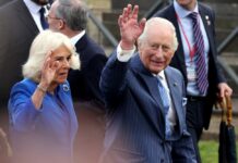 Royal couple waving to the crowd during a public event