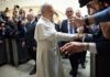 Pope interacting with a crowd of people taking photos