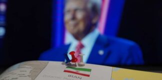 Map of Iran with push pins and a blurred figure in the background