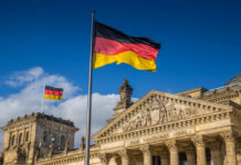 Germany Demands Israel Limit Lebanon Strikes German flag flying in front of the Reichstag building in Berlin