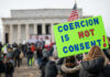 Second American Revolution: Fear Grips Washington A crowd at a protest with a sign reading COERCION IS NOT CONSENT! in front of the Lincoln Memorial