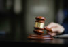 A wooden gavel resting on a desk, symbolizing justice and legal proceedings