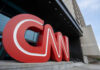 CNN Founder Dies: Controversial Legacy Unveiled Large red CNN logo displayed outside a modern media building