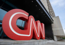 Large red CNN logo displayed outside a modern media building