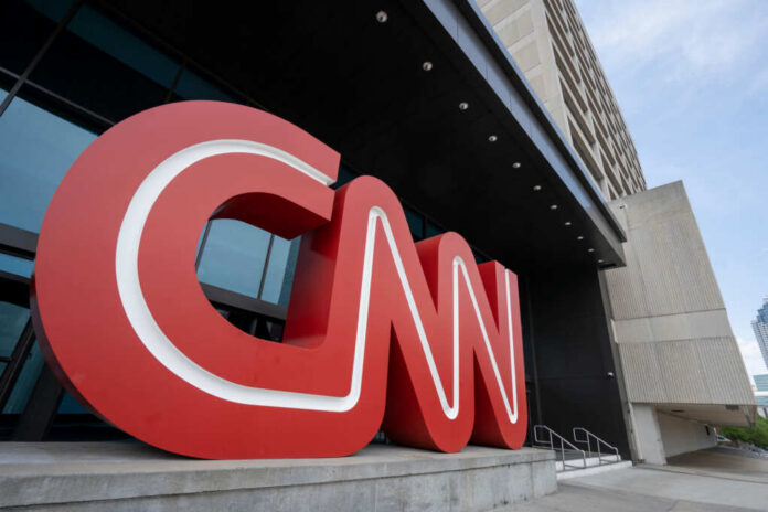 Large red CNN logo displayed outside a modern media building