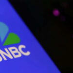 Close-up of the MSNBC logo on a blue background