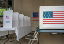 Outrage Erupts: LA Woman’s Ballot Scheme Unveiled Voting booth with American flag and ballot box in a polling station
