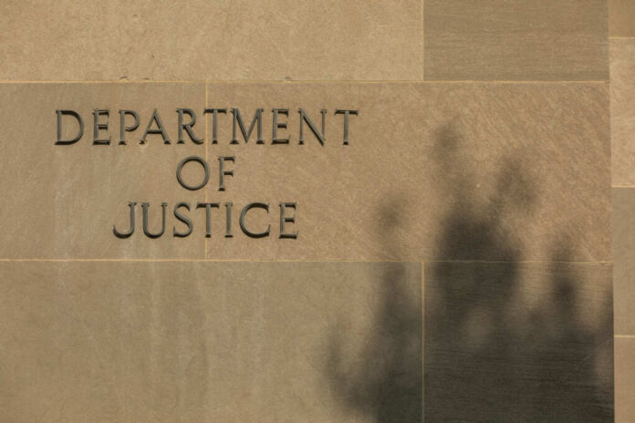 shutterstock2557865709jpg Sign reading Department of Justice on a stone wall with a shadow