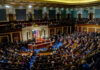 UFO Secrets: Congress Stunned by Alien Claims A large gathering of officials in a congressional chamber during a legislative session