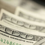 Close-up of several one hundred dollar bills stacked together