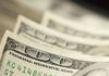 Close-up of several one hundred dollar bills stacked together
