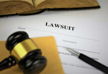 SHOCKING: DOJ Probes Trump Accuser Over Secret Cash A gavel resting on a legal document titled 'LAWSUIT' with a pen and an open book in the background