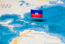 Assassination Fuels Haiti’s Descent into Gang Chaos A small flag of Haiti pinned on a map of the Caribbean Sea