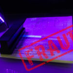 A passport under UV light with a stamp indicating fraud