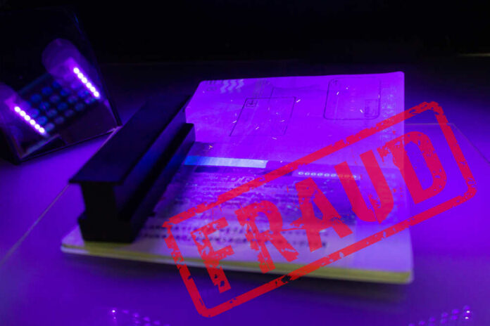 Process,Of,The,Passport,Visa,Checking,,Close-up.,The,Study,Of A passport under UV light with a stamp indicating fraud