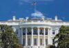 BYSTANDER Wounded in White House Attack! The White House with an American flag flying against a blue sky