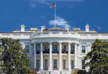 BYSTANDER Wounded in White House Attack! The White House with an American flag flying against a blue sky