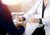 Male Anxiety Overblown? Unmasking The Real Issue A doctor writing notes during a consultation with a patient