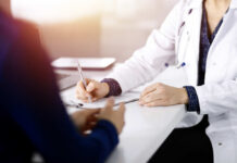 Male Anxiety Overblown? Unmasking The Real Issue A doctor writing notes during a consultation with a patient