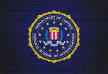 Defector on the Run: FBI’s Massive Reward Announcement FBI emblem on a blue background