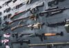 Weapon Switch Sparks Fear of Defense Waste Wall display of assorted firearms and weapons