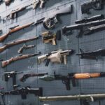 Wall display of assorted firearms and weapons