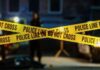Terrifying Knife Attack Rocks Swiss Train Police tape marking a crime scene with blurred figures in the background
