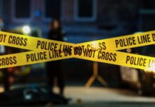 Terrifying Knife Attack Rocks Swiss Train Police tape marking a crime scene with blurred figures in the background