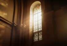 Sunlight streaming through a stained glass window in a church