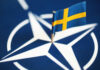 Gang Crisis: Sweden’s Controversial Kid Tracking Small Swedish flag on a NATO emblem background