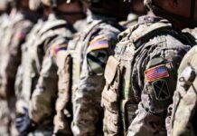 Phone Apps Expose Bases — Congress Panics Line of soldiers in military uniforms with American flag patches
