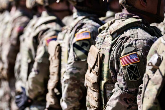 United,States,Army.,Close,Up,Photo,With,The,Flag,Of Line of soldiers in military uniforms with American flag patches