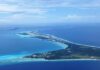 Cool Zone Myth BUSTED at Great Barrier Reef Aerial view of a tropical island surrounded by blue ocean waters