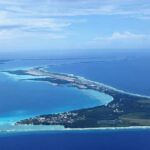 Aerial view of a tropical island surrounded by blue ocean waters