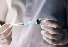 Leaked FDA Memo: Child Deaths Linked to Vaccines? A healthcare professional preparing a syringe from a vial
