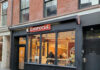 Exterior view of a Chipotle restaurant with customers inside