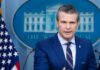 Iran’s Blockade CRUMBLES: U.S. Forces Strike Back A government official speaking at a press briefing in front of the White House backdrop