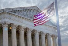 Supreme Court Blasts California’s Secretive Gender Policy The Supreme Court building with an American flag waving in front
