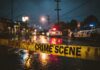 Chicago Bombing Mystery: Explosive Facts Still Missing Police cars at a crime scene with caution tape in the foreground