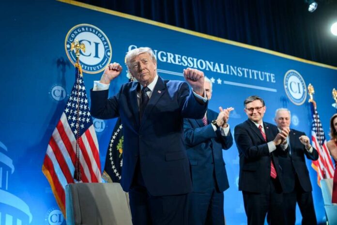 A speaker at a podium celebrating during a political event