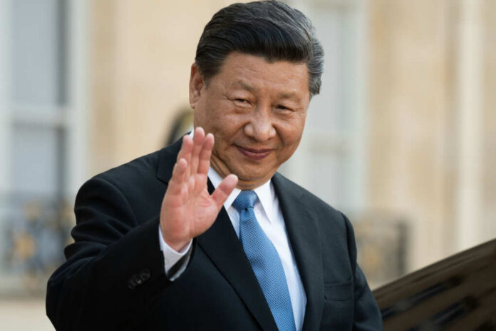 shutterstock1353005396jpg A political leader in formal attire smiling and waving