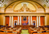 GOP Defectors Hand Democrats a Win Interior view of a legislative chamber with wooden furniture and decorative ceiling