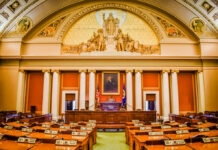 GOP Defectors Hand Democrats a Win Interior view of a legislative chamber with wooden furniture and decorative ceiling