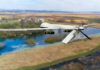 Bomber Bases Breached—No One Saw It Coming A military drone flying over a rural landscape with a river