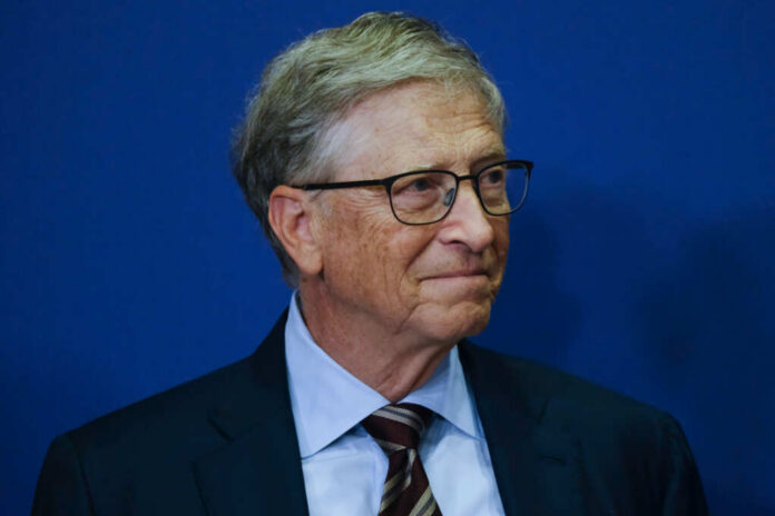 A business leader with glasses smiling in front of a blue background